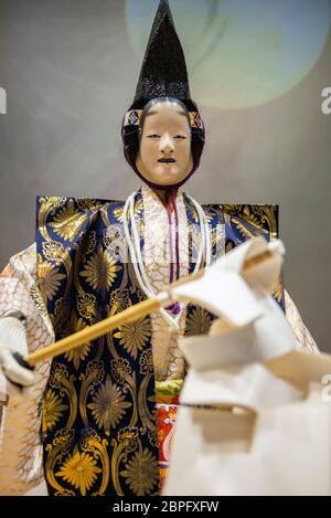 A robot performs a Noh musical drama during the Japan Robot Week exhibition in Tokyo, Japan. Japan Robot Week is a trade show specialized in service robots and robot-related technologies. This event aims to create the future business opportunity by introducing research, development and manufacturing of robots utilized in various scenes, and robotic system integration. Stock Photo