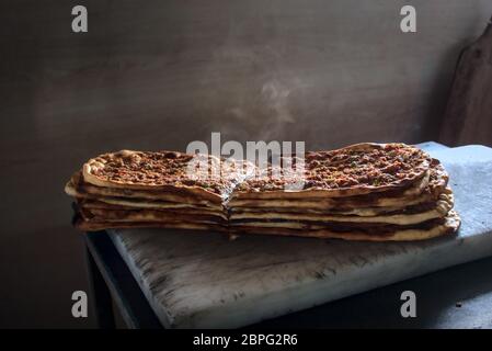 Close up Delicious spicy and steamy stack of traditional Turkish pitas fresh out of oven put on marble ground at Ramadan month Stock Photo