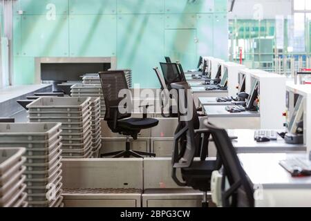 Empty check-in counters at airport terminal due to coronavirus pandemic/Covid-19 outbreak travel restrictions. Lockdown, financial crisis, travel ban. Stock Photo