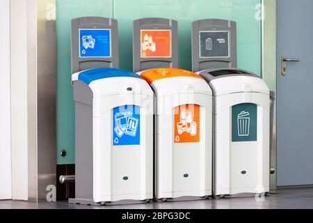Rubbish bins for different garbage - plastic, empty bottles, newspaper, magazine paper and general waste. Stock Photo