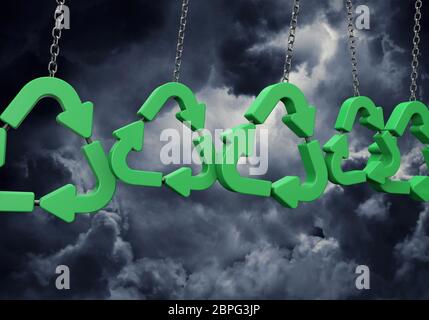 Green recycling symbol hanging from a chain against dark clouds. 3D Rendering Stock Photo