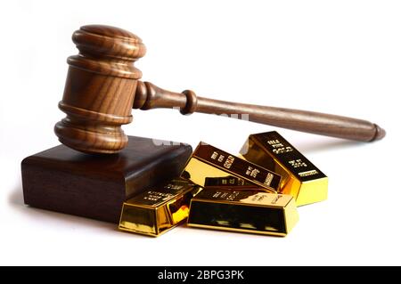 Isolated shot of a legal gavel and gold ingot bar for various financial concepts. Stock Photo