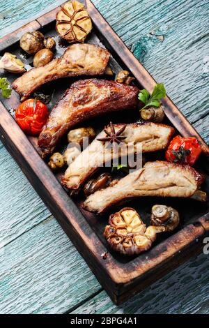 Grilled ribs on vintage wooden cutting board.Summer BBQ Stock Photo