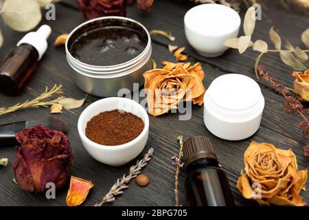 Aromatic botanical cosmetics. Dried herbs flowers mixture, aromatic homemade scrub paste made from coffee grounds and oils. Holistic herbal DIY skinca Stock Photo