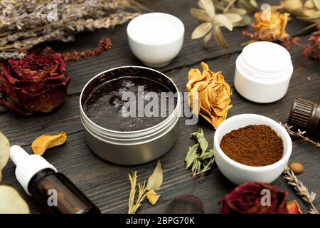 Aromatic botanical cosmetics. Dried herbs flowers mixture, aromatic homemade scrub paste made from coffee grounds and oils. Holistic herbal DIY skinca Stock Photo