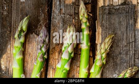 Bunch of fresh green asparagus spears rich in vitamin, glutathione,  minerals, on old rustic wooden background Stock Photo - Alamy