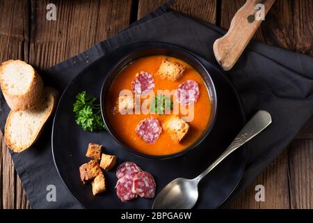 Hungarian paprika cream soup with spicy sausage Stock Photo