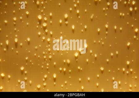 raindrops on a yellow plastic surface. Stock Photo