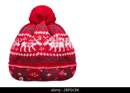 Red winter knitted hat with patterns on a white background. Stock Photo