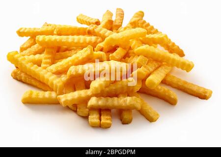 Heap of crispy golden crinkle cut potato chips or Pommes Frites on a white background for a menu Stock Photo