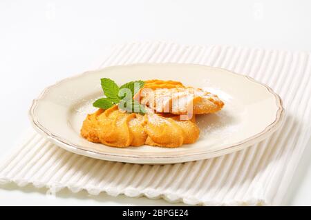 Spritz butter cookies on plate Stock Photo