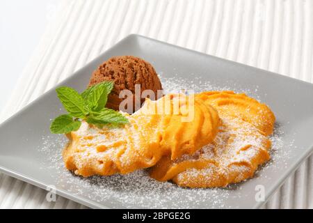 Spritz butter cookies and scoop of chocolate ice cream Stock Photo