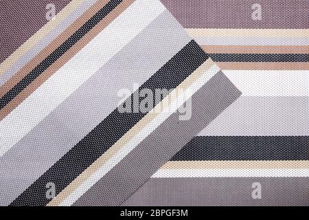 Striped background. Top view of details of colorful striped background texture with seamless pattern on plastic tissue. Macro. Stock Photo