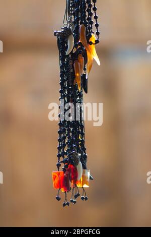 Handmade jewelry hangs on display outside a small souvenir shop in Lahic, Azerbaijan Stock Photo