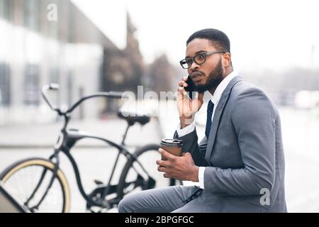 Handsome businessman having business talk in park Stock Photo