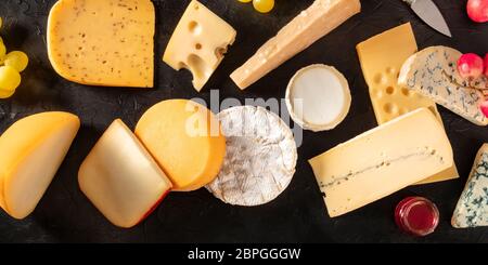 Cheese variety panorama, shot from above on a black background Stock Photo