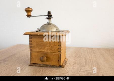Ancient coffee grinder on a table Stock Photo