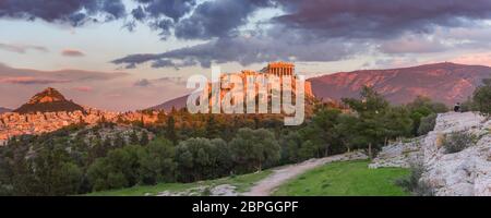Aerial panoramic view of the Acropolis Hill with Parthenon and Mount Lycabettus at gorgeous sunset in Athens, Greece Stock Photo