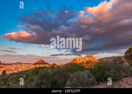 Aerial panoramic view of the Acropolis Hill with Parthenon and Mount Lycabettus at gorgeous sunset in Athens, Greece Stock Photo