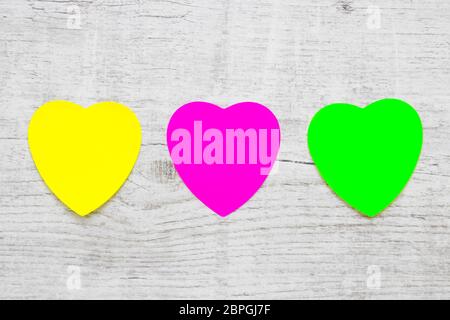 Colorful Heart Note Papers on wooden background Stock Photo