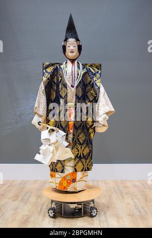 A robot performs a Noh musical drama during the Japan Robot Week exhibition in Tokyo, Japan. Japan Robot Week is a trade show specialized in service robots and robot-related technologies. This event aims to create the future business opportunity by introducing research, development and manufacturing of robots utilized in various scenes, and robotic system integration. Stock Photo