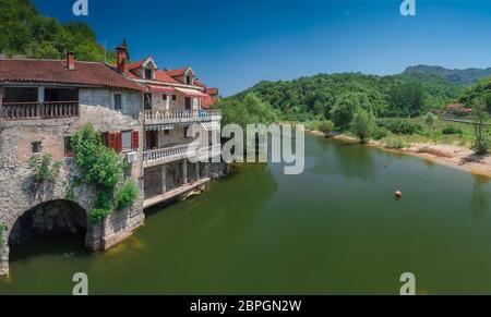 Skadar lake, Montenegro - 07.15.2018.  Panoramic view of the Old Bridge over Crnojevica river, Rijeka Crnojevica, and the tourist area near the bridge Stock Photo