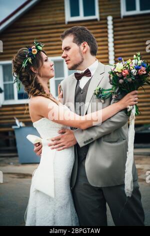 bride and groom in the background of the house. Stock Photo