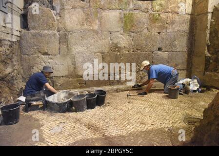 Jerusalem, Israel. 19th May, 2020. Antiquity workers repair a mosaic floor unearthed the Israel Antiquities Authority on Tuesday, May 19, 2020, in the Old City of Jerusalem. Archeologists have discovered an unique subterranean system in the bedrock of the Second Temple Period beneath a 1400 year-old public building in the underground excavations under the Western Wall. Photo by Debbie Hill/UPI Credit: UPI/Alamy Live News Stock Photo