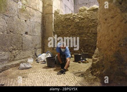 Jerusalem, Israel. 19th May, 2020. An antiquity worker cleans a mosaic floor unearthed by the Israel Antiquities Authority on Tuesday, May 19, 2020, in the Old City of Jerusalem. Archeologists have discovered an unique subterranean system in the bedrock of the Second Temple Period beneath a 1400 year-old public building in the underground excavations under the Western Wall. Photo by Debbie Hill/UPI Credit: UPI/Alamy Live News Stock Photo