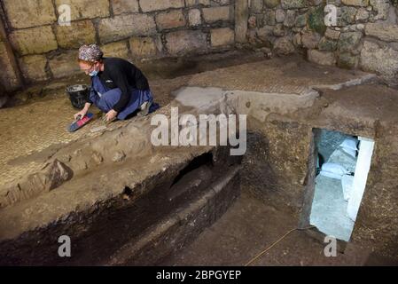 Jerusalem, Israel. 19th May, 2020. Israeli archaeologist Tehila Sadiel cleans a mosiac floor unearthed by the Israel Antiquities Authority on Tuesday, May 19, 2020, in the Old City of Jerusalem. Archeologists have discovered an unique subterranean system in the bedrock of the Second Temple Period beneath a 1400 year-old public building in the underground excavations under the Western Wall. Photo by Debbie Hill/UPI Credit: UPI/Alamy Live News Stock Photo
