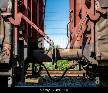 Connection mechanism of railway wagons. Railway coupling between two wagons Stock Photo