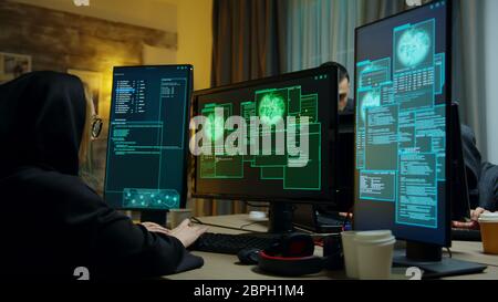 Happy hacker team after a successful cyber attack. Access granted for girl cyber criminal. Stock Photo