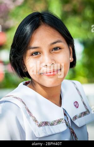A beautiful Filipino school girl poses in a park in Angeles City, Philippines. Stock Photo