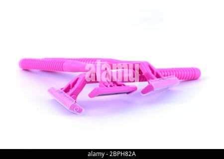 An isolated set of three new pink razors for womans hair removal. Stock Photo