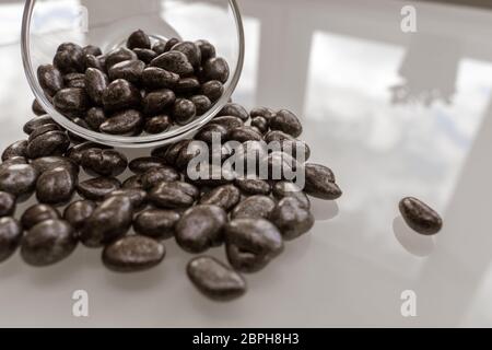 raisin sweets in chocolate closeup. uneven marble coating Stock Photo