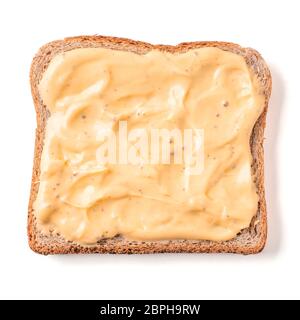 Bread slice with mustard sauce isolated on white, clipping path. Slice of multigrain bread square form plaster mustard sauce for toast. Image of one s Stock Photo