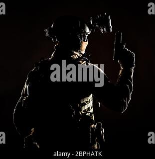 Army elite forces soldier, police special operation, counter terrorist team member in tactical ammunition with hidden behind mask identity, standing b Stock Photo