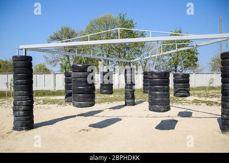 Homemade punching bags from car tires. Sports ground in the courtyard. punching bags Stock Photo