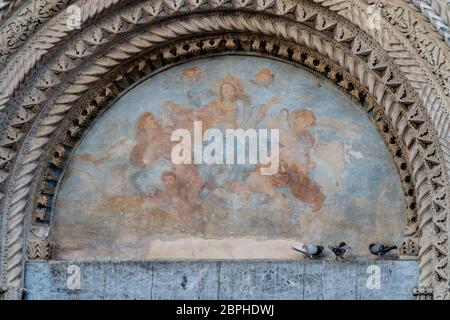 Atri, Teramo, Italy, August 2019: Fresco above the gate of the Cathedral of Atri, Basilica of Santa Maria Assunta, national monument since 1899, Gothic architecture Stock Photo