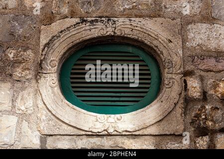 Kotor old town, a small window on stone wall, 02 January 2020, Montenegro Stock Photo