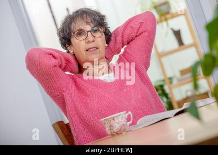 portrait of a beautiful mature woman dressed with a pink sweater Stock Photo
