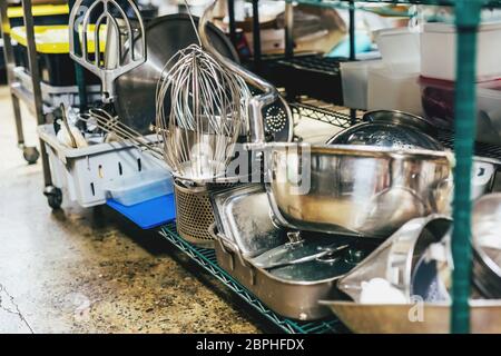 Kitchen utensils on shelves in an industrial kitchen. Stock Photo