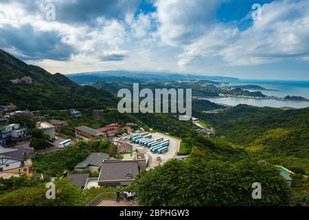 Jiufen, Taiwan - November 07, 2018: Tourists watch panoramic view over the coastline of Taiwan from the hill on November 07, 2018 in Jiufen, Taiwan Stock Photo