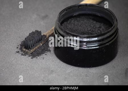 Charcoal on a toothbrush to whiten teeth beauty concept Stock Photo