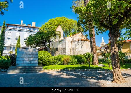 Croatia, town of Lovran, beautiful old stone chapel in mediterranean style park Stock Photo