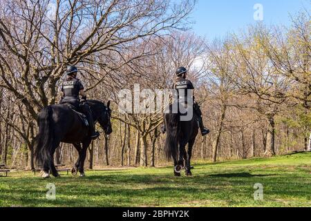 Montreal, CA - 18 May 2020: Horse Mounted Police in Mount Royal Park Stock Photo