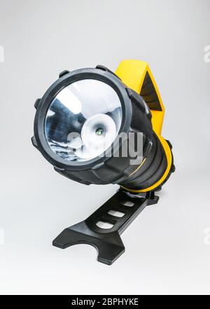 big yellow flashlight hand held with adjustable angle isolated on white background.. Stock Photo