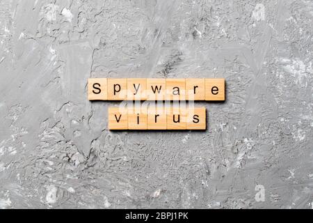 Spyware virus word written on wood block. Spyware virus text on cement table for your desing, concept. Stock Photo