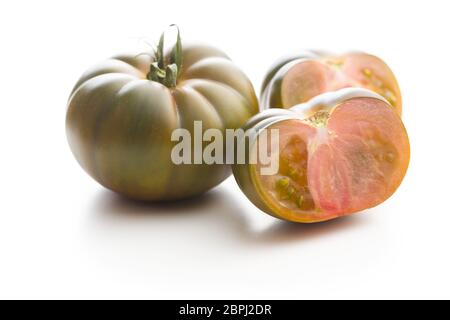 Dark brandywine tomatoes isolated on white background. Stock Photo