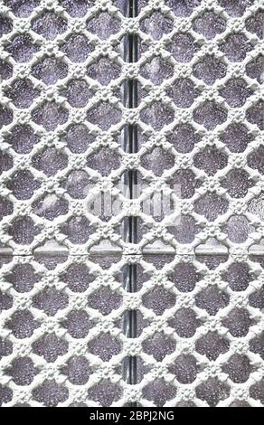 Old metal gate decorated, detail of an old fence painted white, protection and decoration Stock Photo